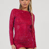 A person with long braided hair is wearing the IF LOOKS COULD KILL Rhinestone Mini Dress in red, showcasing a curve-hugging silhouette. Holding sunglasses, they strike a confident pose in the sparkly, fitted dress made from stretchy mesh knit against a plain background.