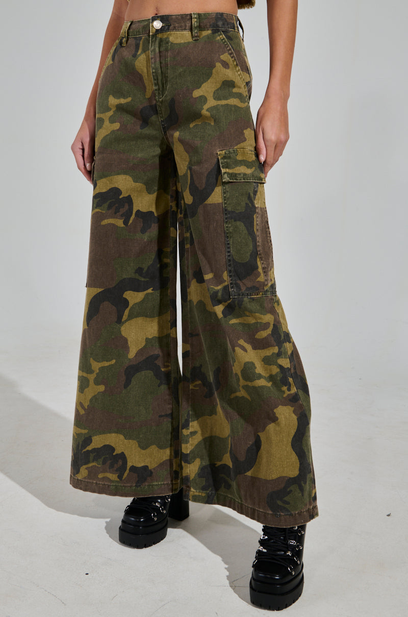 Someone is wearing the RIDE WITH ME CAMO WIDE LEG PANT with black platform boots, shown only from the waist down against a plain backdrop.