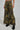 Someone is wearing the RIDE WITH ME CAMO WIDE LEG PANT with black platform boots, shown only from the waist down against a plain backdrop.
