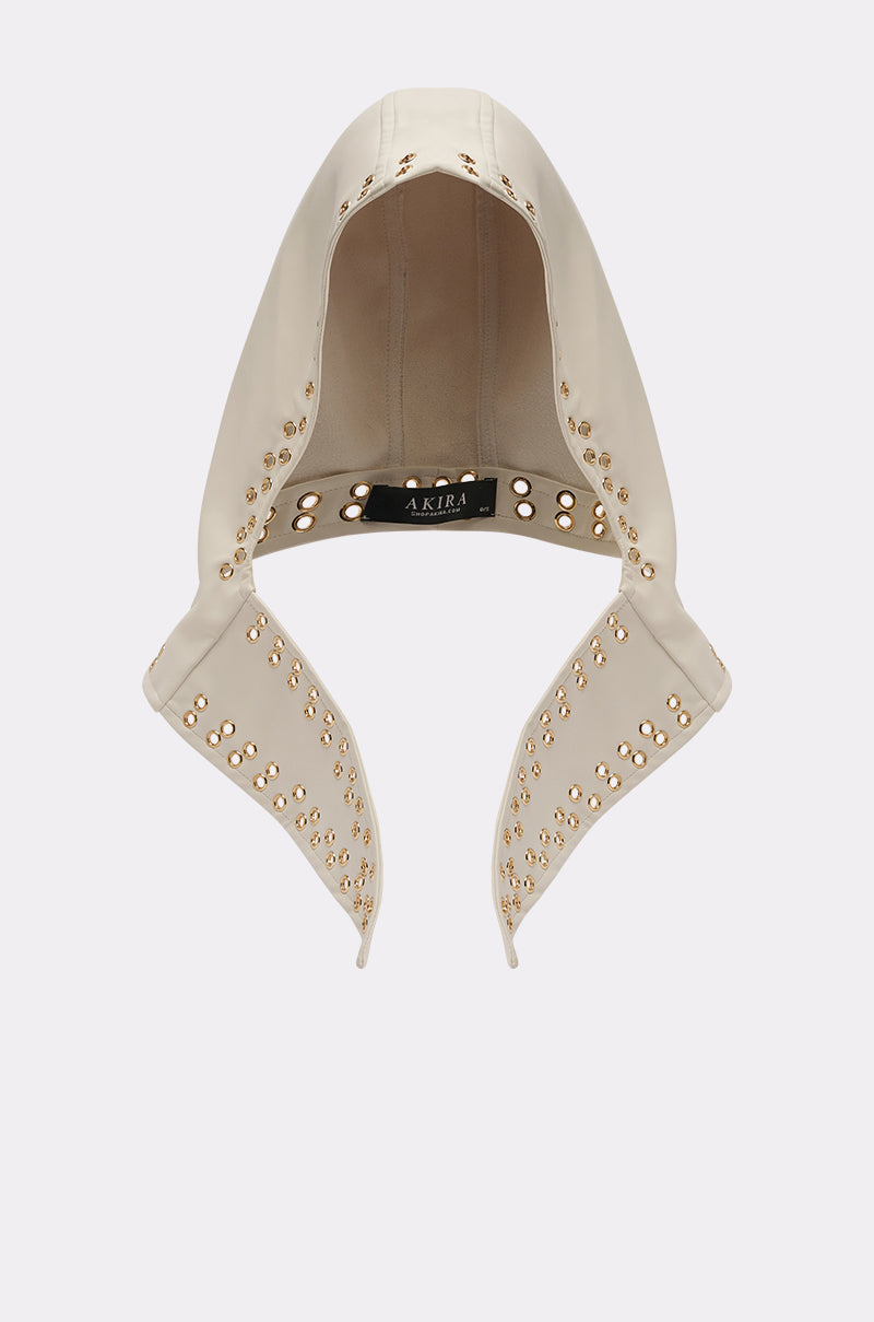 The THAT GURL PU GROMMET HEADSCARF, a cream-colored streetwear accessory with gold studs and grommet detailing on the edges and an "AKIRA" label inside, is displayed against a plain white background. 1