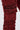 Close-up of the IT GETS EASIER STACKED CARGO PANT IN BURGUNDY, showcasing a large flap pocket with visible dark seams and distressed details against a plain light background.