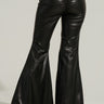 A person is seen from behind wearing the YES PLEASE FAUX LEATHER PANT, which features a black, high-rise fit with flared legs and gathered detailing at the waistband. The pants have a shiny finish as the individual stands against a neutral background.