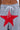A close-up of a person wearing SEE YOU NEXT TUESDAY PANT—gray sweatpants with a large red star patch, white bow-tied drawstrings at the waist, and standout star-shaped metal studs.