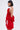 A woman with straight dark hair models the CHIC AF RUFFLE MINI DRESS IN RED, featuring lustrous satin, spaghetti straps, and oversized ruffle details. She stands in profile against a plain white background with large hoop earrings.