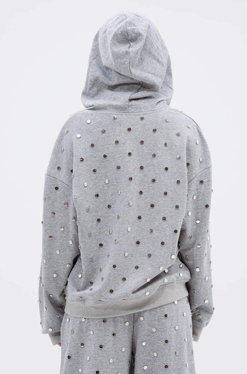 A person is shown from the back against a plain white background wearing the POPPING OFF ZIP UP SWEATSHIRT and matching pants, both gray and embellished with small, shiny metallic studs.