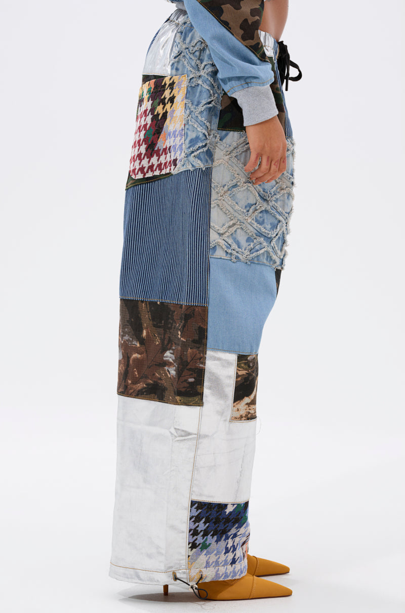 A person stands sideways in WILD AND FREE DENIM JOGGER pants, channeling streetwear style with a mix of textured denim and pairing them effortlessly with pointed yellow shoes. 4