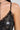A close-up of a woman's upper body showcasing the TWO IS BETTER THAN ONE LACE LAYERED MIDI DRESS, featuring black sheer mesh lace and sequin embellishments. She accessorizes with a silver necklace adorned with a clear pendant. The focus is on the intricate lace details and shimmering sequins that enhance the elegance of her style.