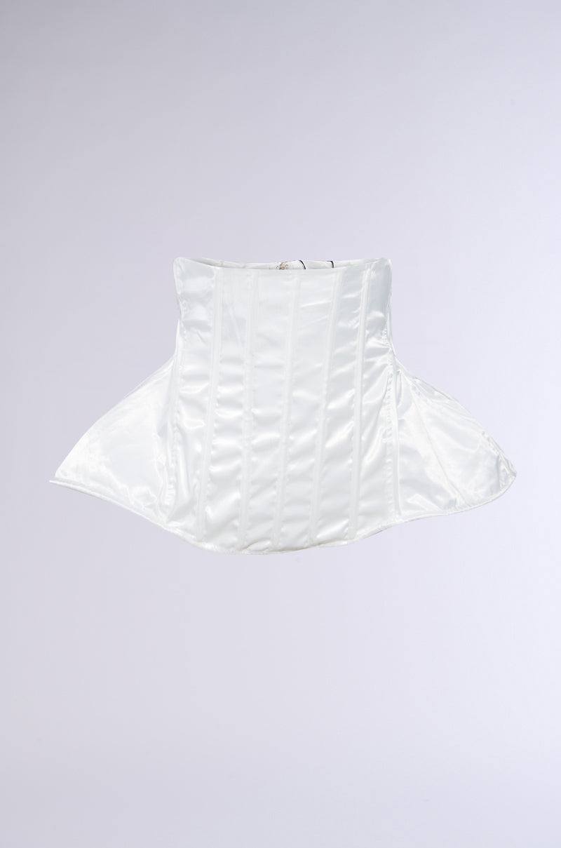 The IM TOO GOOD FLARE BELT is a white satin corset with vertical boning and a structured peplum silhouette, shown against a plain light gray background. 2