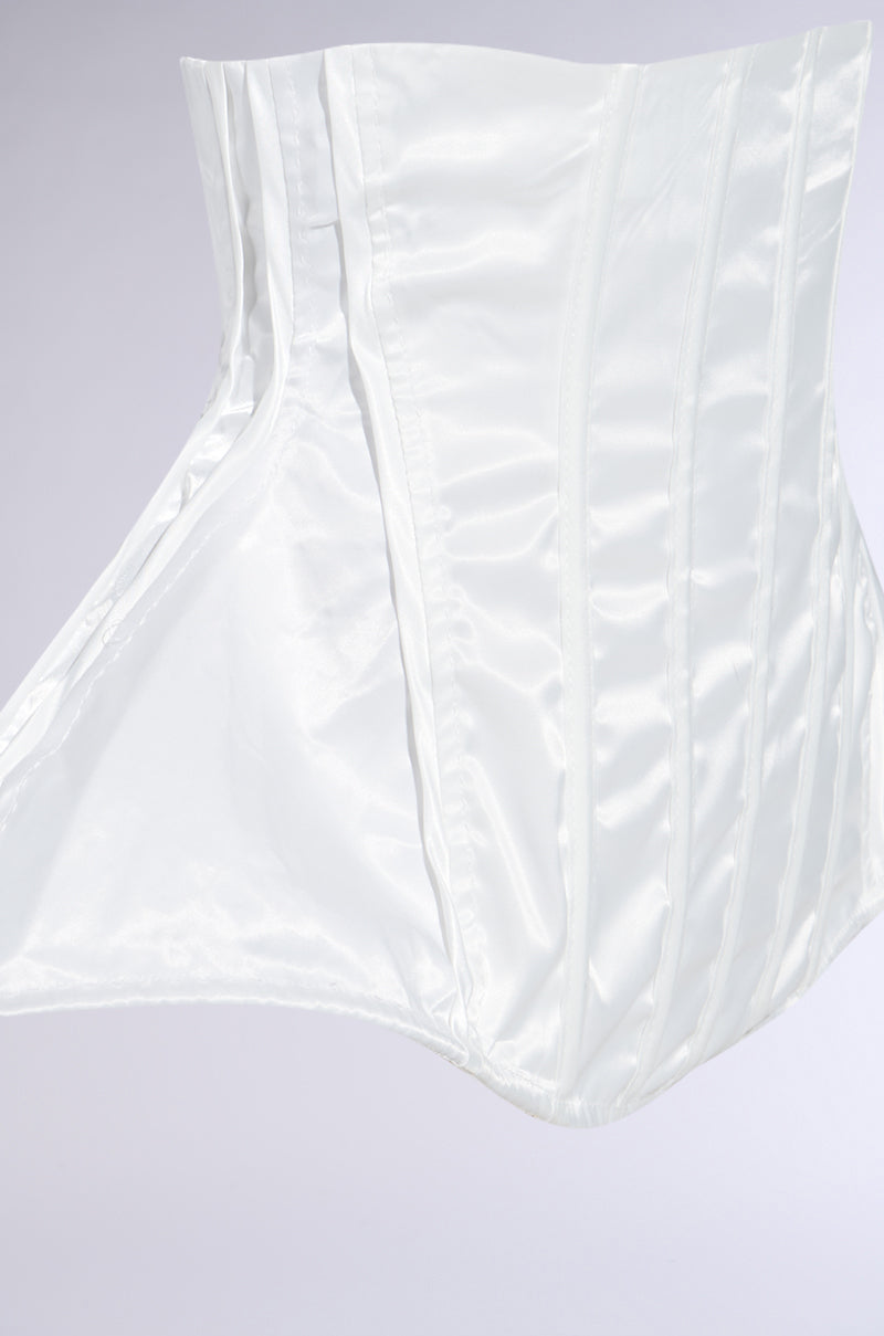 The IM TOO GOOD FLARE BELT is a glossy white satin structured corset with pronounced boning and a dramatic flared peplum silhouette, shown against a light gray background. 4