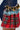 A close-up of the CALL ME BACK DENIM SKIRT WITH PLAID DETAIL showcases its ruffled layers in diverse plaid designs, including shades of red, blue, and yellow. The skirt's asymmetrical shape and textured fabric create a lively contrast with the denim.