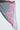 THE JULIE BLOUSE features a sheer black fabric with a tie-front closure and a vibrant floral pattern in pink, purple, and green. Its flowing material highlights both its translucent quality and intricate flower design.