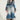 A person confidently stands wearing the LIV FUR TRIM DENIM TRENCH, featuring a chic fur trim collar and cuffs. They have long, curly hair and sport trendy sunglasses. Their outfit is completed with fur boots, and they carry a small bag.