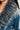 Close-up of a person wearing the LIV FUR TRIM DENIM TRENCH, highlighting the texture and details of the denim fabric and the gray faux fur trim collar.