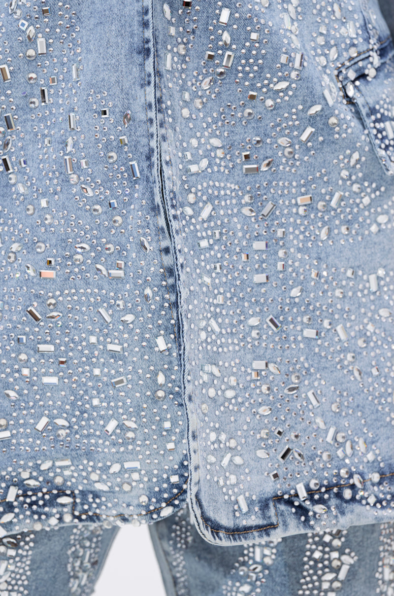 Close-up of the DIAMONDS DANCING DENIM BLAZER, an oversized blazer decorated with sparkling rhinestones and metallic studs in diverse shapes and sizes for a striking, intricate look.