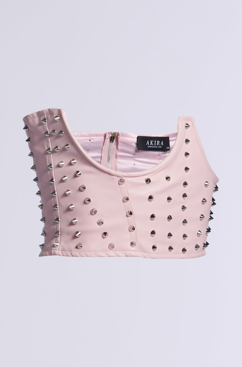 The PRETTY BUT I BITE SPIKE BELT features a light pink faux leather crop top with a back zipper and metallic spikes on the front and shoulders, all set against a plain background. 3