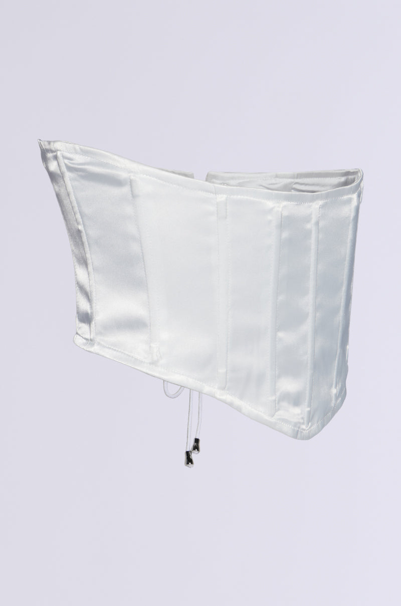 The PAIR ME CORSET BELT, featured against a simple light background, is a white satin corset belt showcasing a lace-up back design. Made from stretchy satin, it is structured to offer both shape and support.