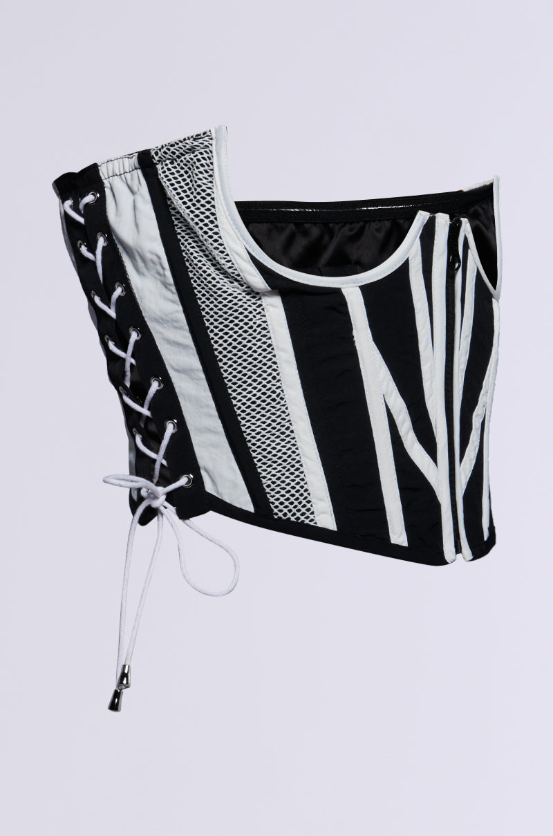 The TO THE RACES NYLON BELT from the AKIRA Label, showcasing a black and white colorblock design with vertical stripes, mesh panels, and a lace-up detail on one side, against a plain light background. 4