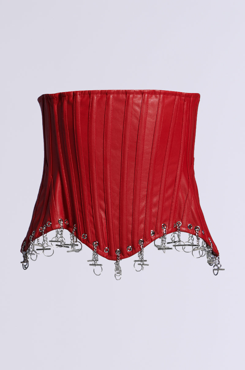The FASHUN STRUCTURED CORSET CHARM BELT is a red faux leather corset, featuring structural boning with silver chains and hooks. Its vertical stitching and pointed hem create an edgy look against a light background.