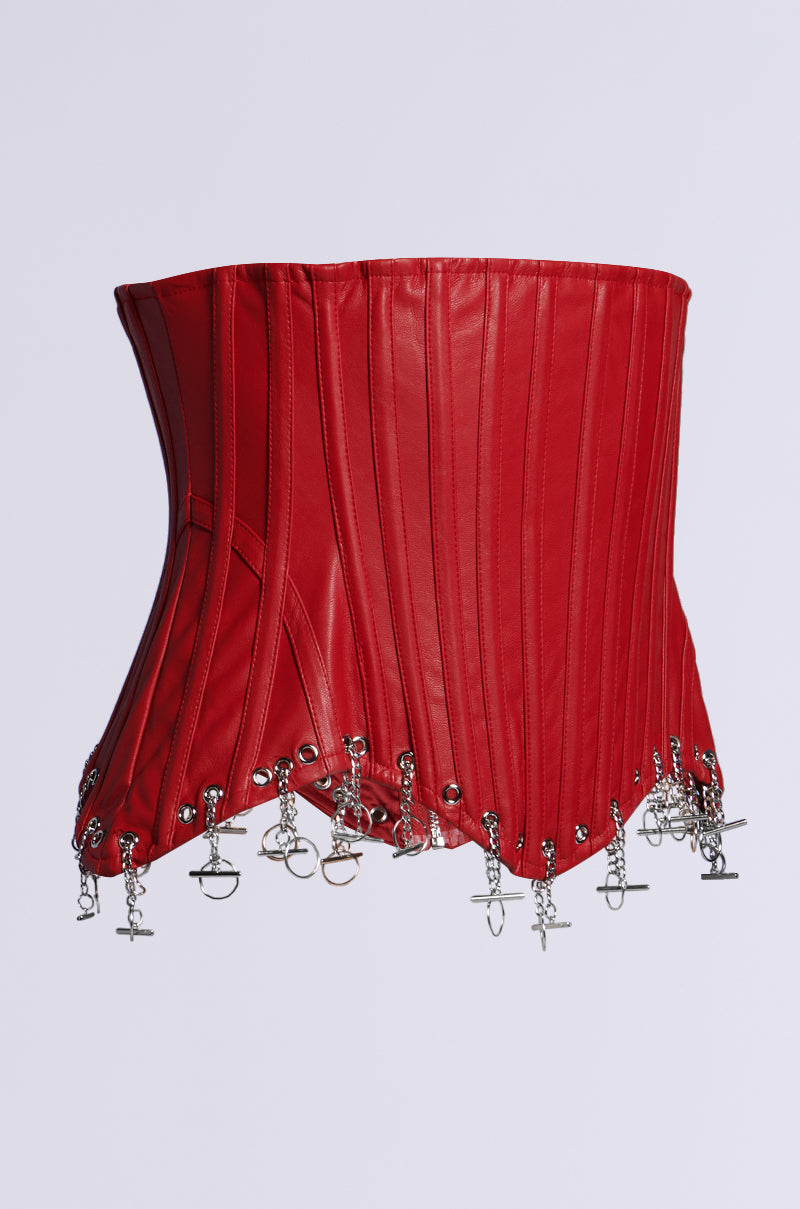 The FASHUN STRUCTURED CORSET CHARM BELT, a striking red faux leather corset with structural boning and vertical stitching, is elegantly highlighted against a plain white background. It features a silver chain charm belt adorned with small locks and keys.