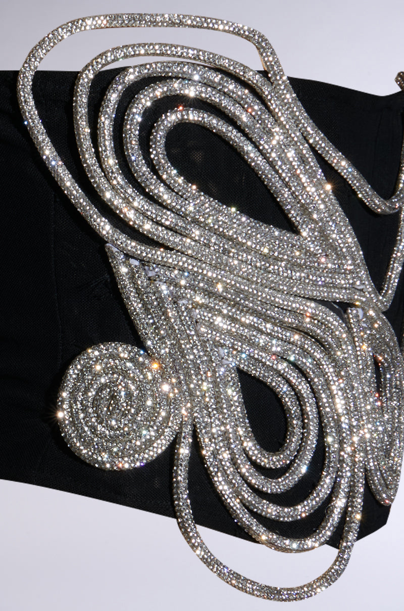 The IM A WONDER RHINESTONE STRETCH BELT features a luxurious, corset-inspired design with an elaborate spiral of sparkling rhinestones beautifully arranged over a black fabric background, creating an ornate waist-cinching accessory.