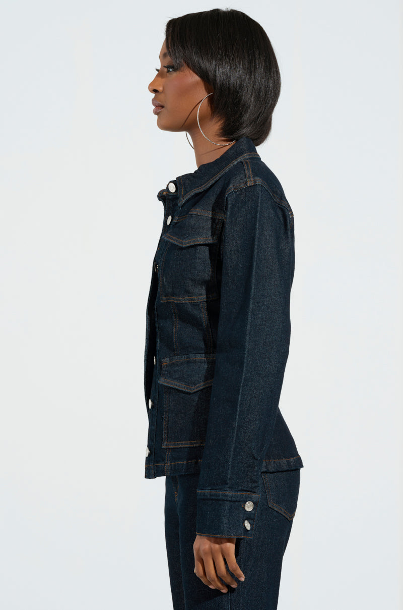 Profile view of a person wearing an EVERYDAY LIVIN' Denim Button Down Shirt along with matching pants. The individual, epitomizing the essence of Everyday Livin’, has shoulder-length hair and is standing against a plain white background.