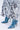 The denim high-heeled boots feature pointed toes and are perfectly matched with the EXPENSIVE TASTE STRETCHY SEQUIN CHAIN PANTS, which are decorated with large silver sequins and chain link details, offering a dazzling textured look.