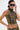 A person with short dark hair and a bleached streak wears large sunglasses, gold ear cuffs, a septum ring, has tattoos on their arm and torso, and is styled in the DARIA STUDDED CAMO SIDE LACE TOP.