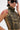 Wearing large sunglasses and a nose ring, this person styles the DARIA STUDDED CAMO SIDE LACE TOP with animal print, showing off a bold red shoulder tattoo while touching the side of their head.