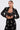 A woman in the OLD FLAME EMBELLISHED BLAZER IN BLACK with pearl accents over a black lace bralette stands holding her jacket, gazing to the side with a neutral expression against a plain background.