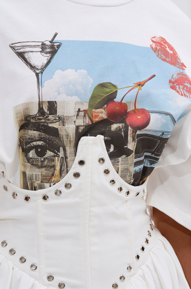 A close-up of a person wearing the COOL GIRL LOADING MINI DRESS WITH GRAPHIC TEE ATTACHED, featuring playful graphics and a high-waisted corset-style bodice with metal eyelets and buttons.