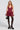 A woman in a sleeveless STYLE AND GRACE POPLIN MINI DRESS, burgundy and corset-inspired, paired with black lace thigh-high stockings, holds a small black bag. She completes her look with black platform heels and stands against a plain light background.