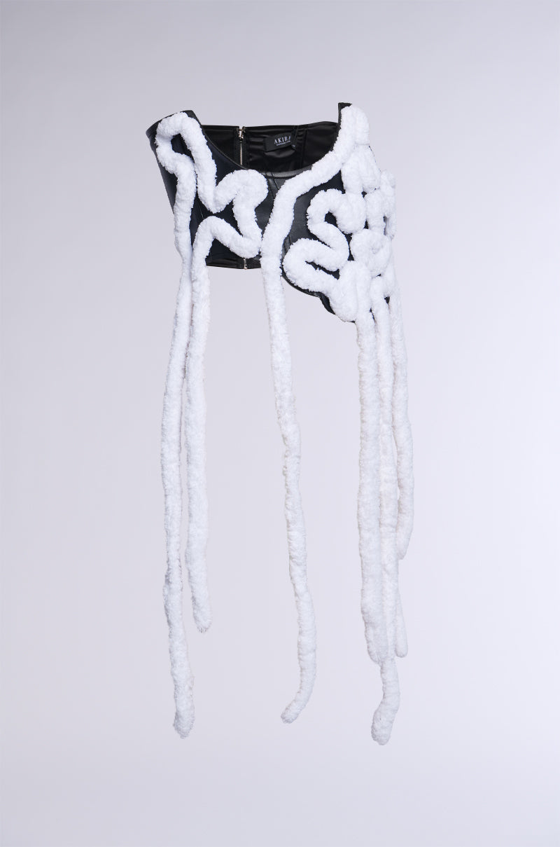 The AESTHETIC APPLIQUE CORSET BELT is a black corset belt featuring long, white sherpa yarn tendrils elegantly cascading down against a plain background.
