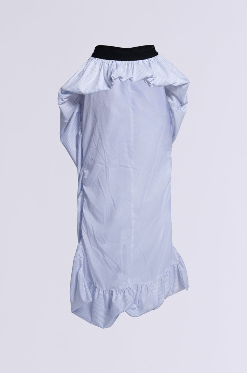 The RUNWAY BELT SKIRT, a white ruched piece with a bubble hem, is showcased against a plain background. It includes a black collar and ruffled accents at the neckline and hem, adding texture for high-fashion appeal.