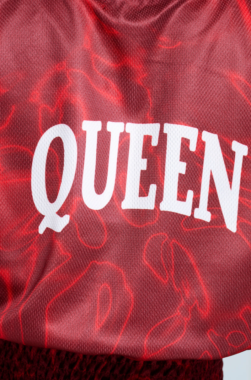 Close-up of the YOURE A ROOKIE JERSEY IN RED, a sleeveless top with a subtle floral pattern and "QUEEN" in bold white letters, offering a distinct Brooklyn graphic vibe.