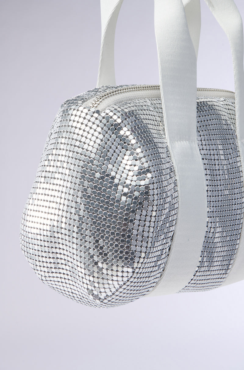 A close-up of the shimmering silver TO THE DISCO CHAINMAIL PURSE, featuring sparkling sequins, white handles, and a white zipper against a simple light background.