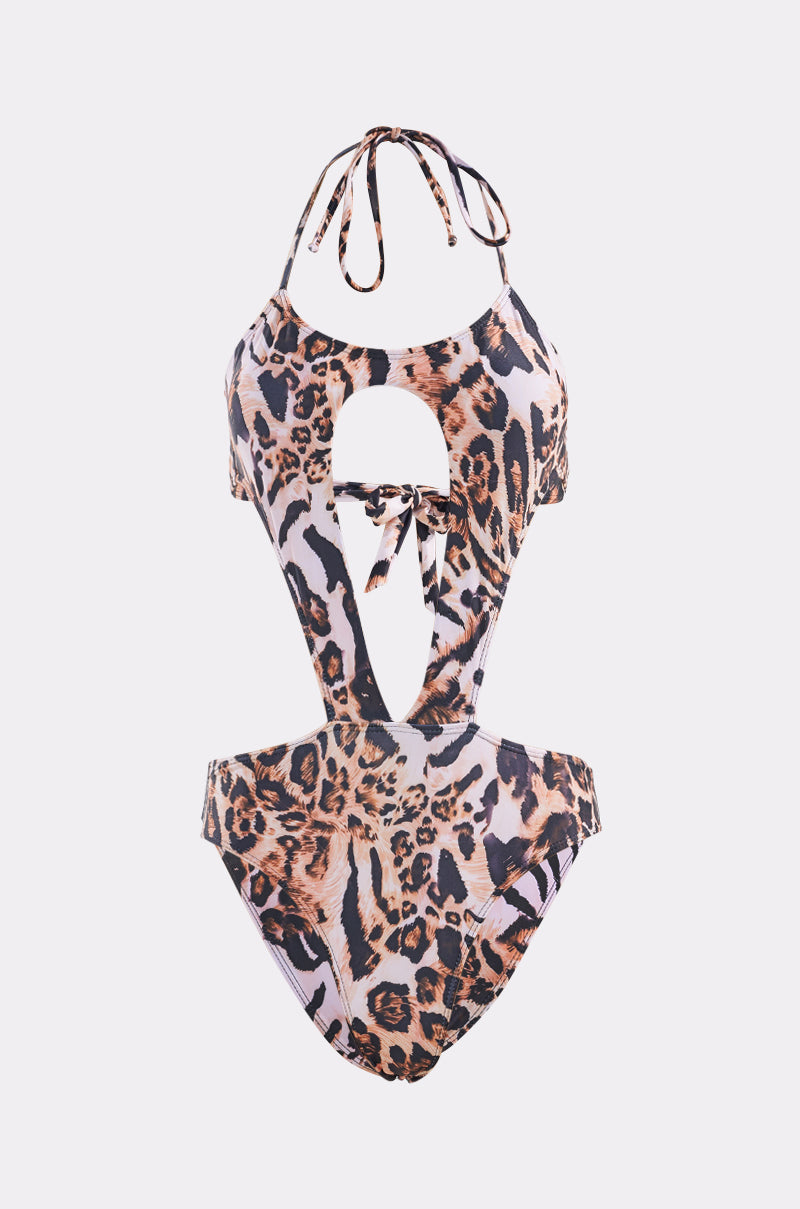 The WILD SIDE ONE PIECE SWIMSUIT features a halter neck tie, front cut-out with center knot, and a bold black, brown, and tan leopard print design. 3