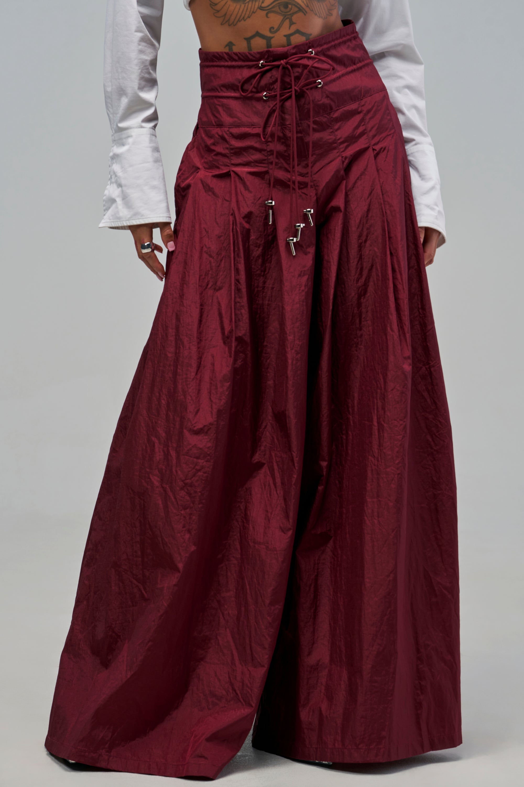 DANCE THE NIGHT AWAY PALAZZO PANT IN BURGUNDY: wide-leg palazzo pants with a high-waisted, lace-up front design.