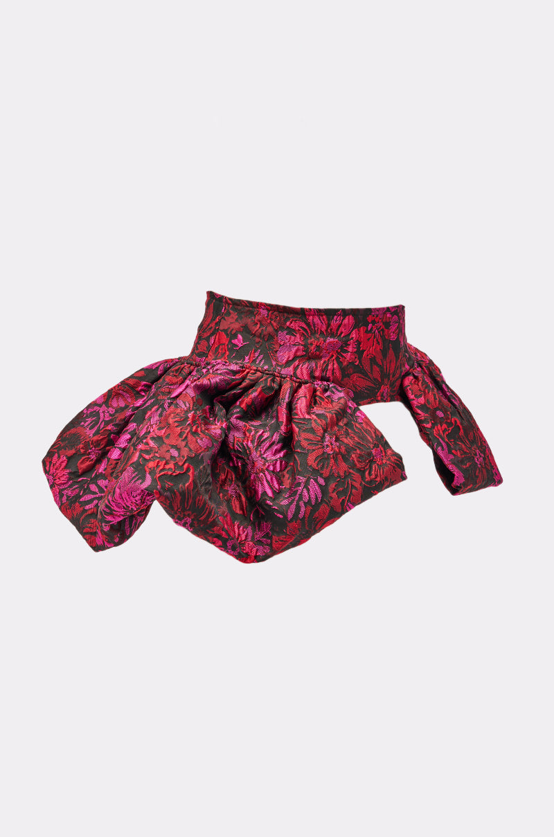 The NIGHTLY FLORAL PEPLUM BELT is a gothic chic accessory featuring jacquard fabric, a striking bow, and vivid red and pink florals set against a dark motif on a light gray background. 7