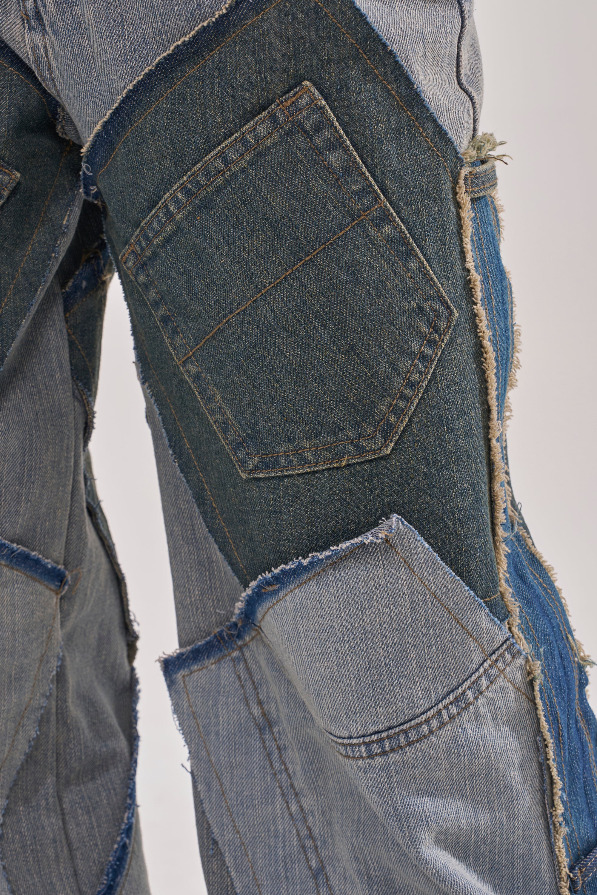 Close-up of ALL THAT WIDE LEG DENIM JEANS with distressed patchwork, denim patches in blue tones, frayed edges, visible stitching, and a pocket for an authentic Y2K street style look. 8