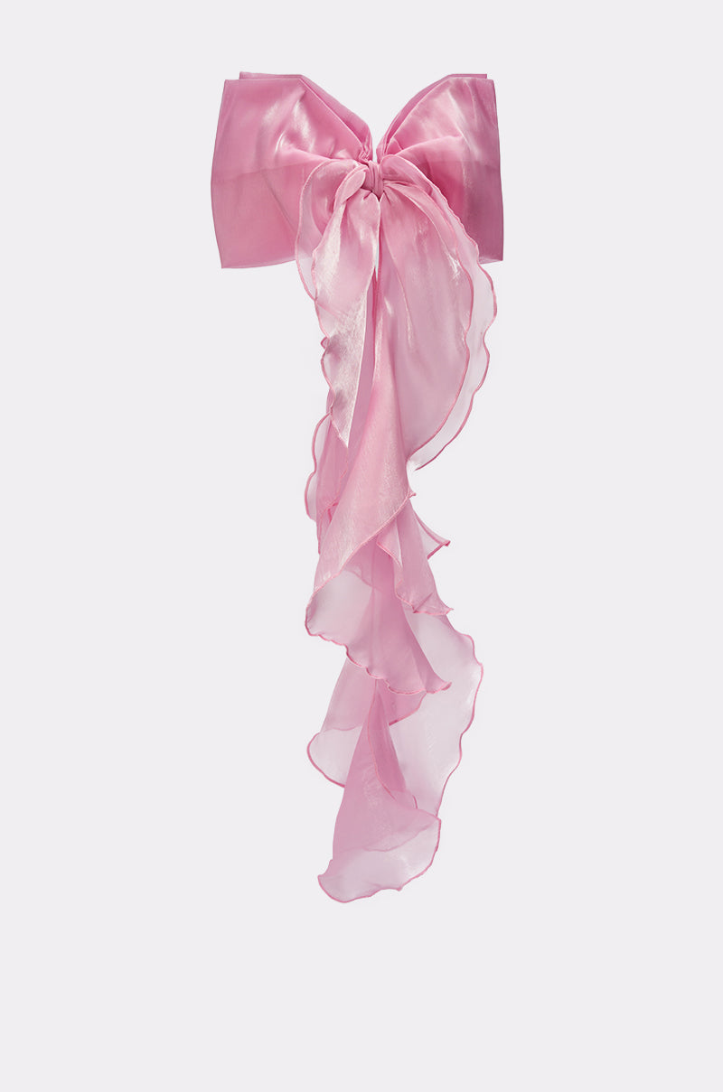 The MY LOVE CHIFFON HAIR BOW is a large, sheer pink accessory with long, ruffled tails, creating an eye-catching statement against any backdrop. 2