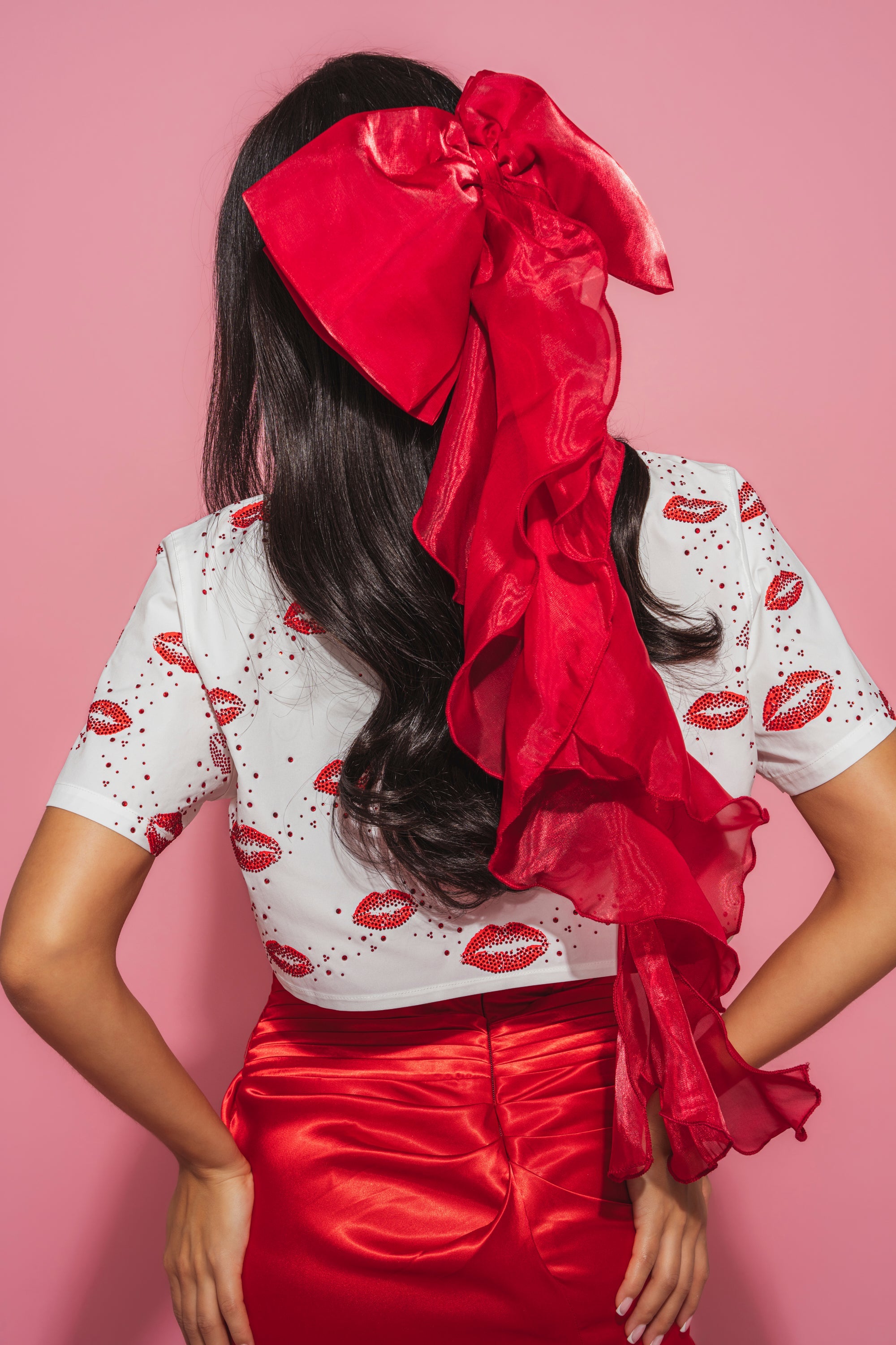 A woman wearing a red hat, white shirt, and the HEY DOLL CHIFFON HAIR BOW. 0