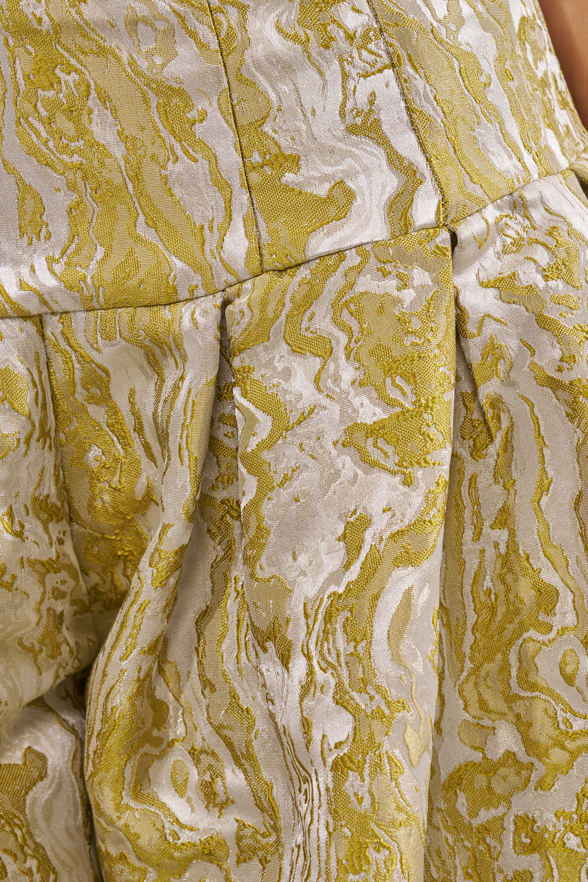 Close-up of the GET IT FLORAL TROUSER fabric in yellow and light beige with a wavy, marbled pattern and pleats—perfect for statement brunch outfits or chic wedding guest looks. 9