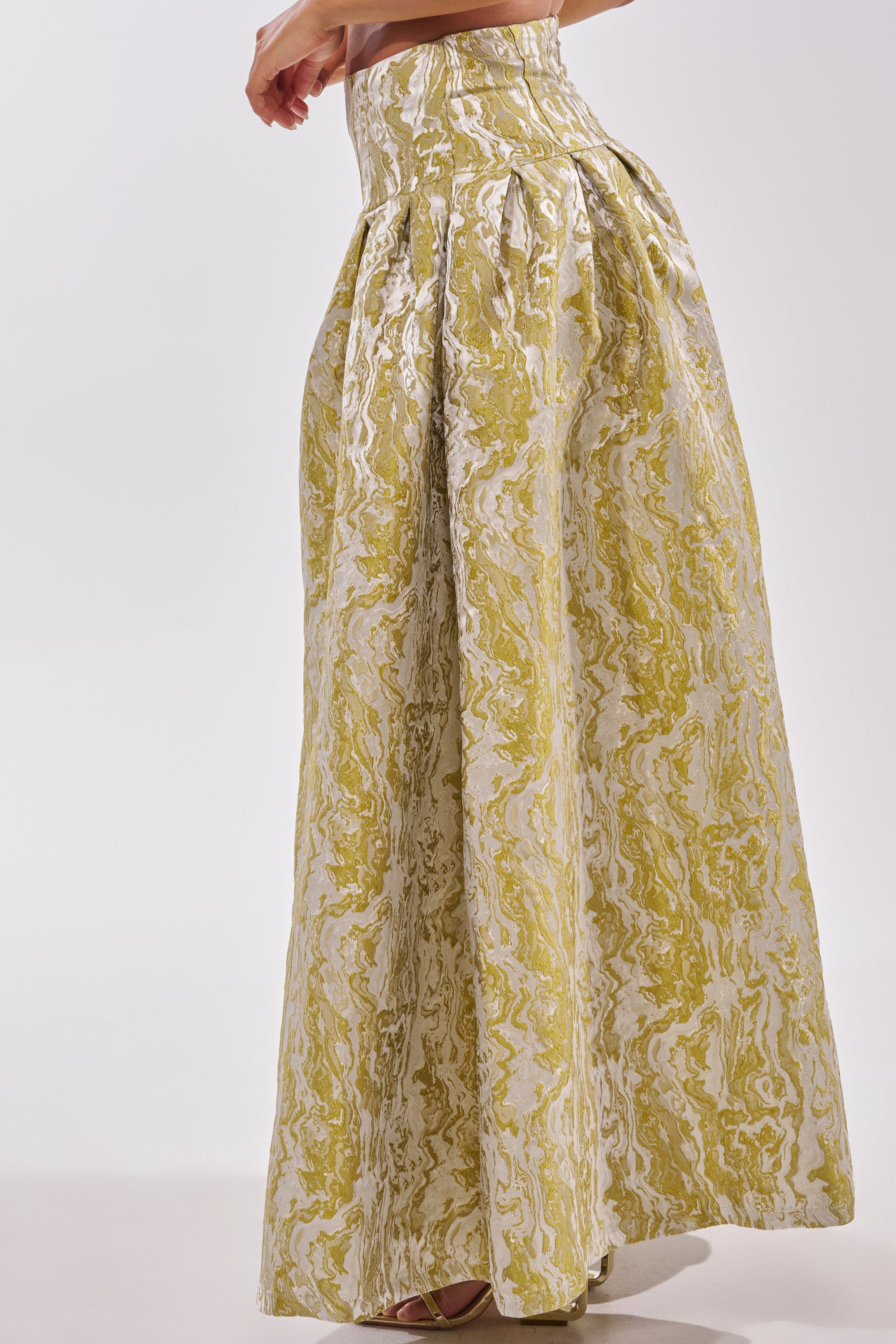 A person wears the GET IT FLORAL TROUSER, featuring a high waist and a yellow and white marbled print, standing against a plain light background—ideal for statement brunch style or chic wedding guest looks. 4
