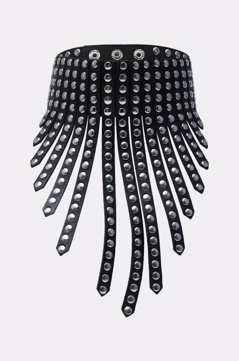 The EDGY VIBES NECKLACE is a black choker adorned with multiple long leather straps and silver grommets, creating a bold, fringed style. The band features silver eyelets for adjustable fastening.