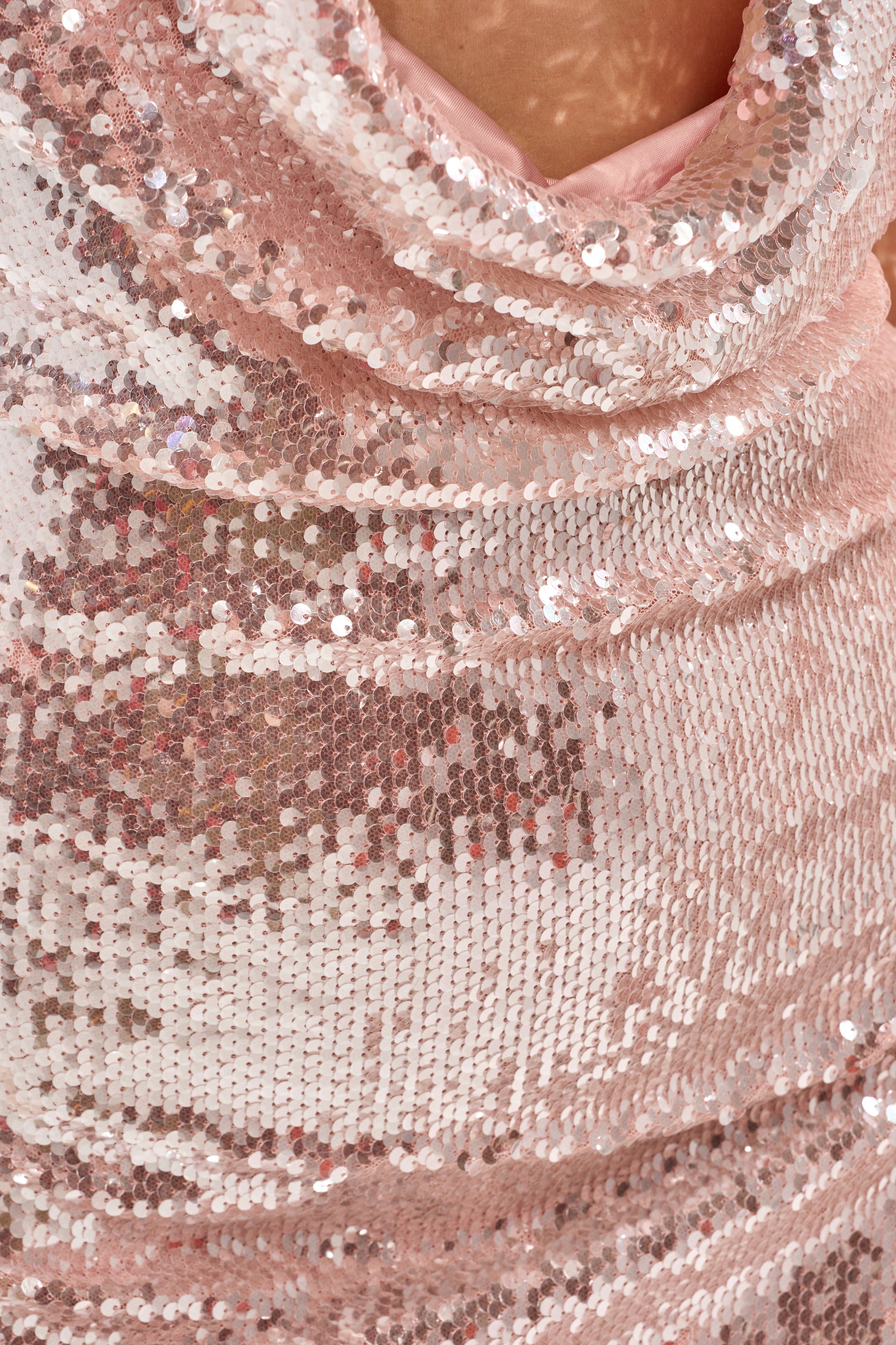Close-up of the LIGHT UP THE ROOM SEQUIN MINI DRESS IN LIGHT PINK, featuring blush sequins and soft folds that reflect light for a shimmering effect—an ideal choice for your next cocktail party. 7