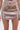 A close-up of a person wearing the SPARKLE QUEEN SEQUIN MINI SKIRT with hands at their sides, showcasing luxe sequin embellishments against a plain white background.
