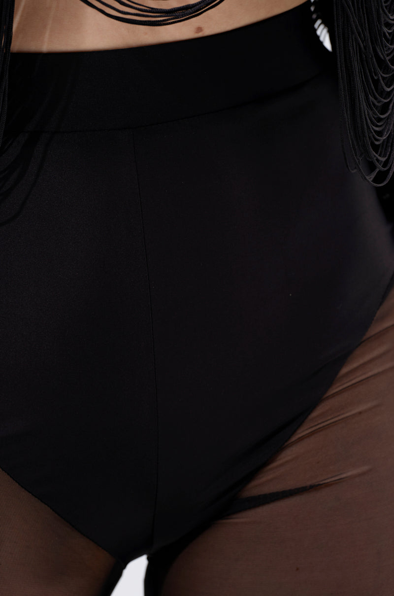 Close-up of a person wearing the IT ONLY GETS BETTER MESH FLARE LEGGING featuring ultra-high waist and sheer mesh side panels, with a decorative black necklace visible at the top. 8