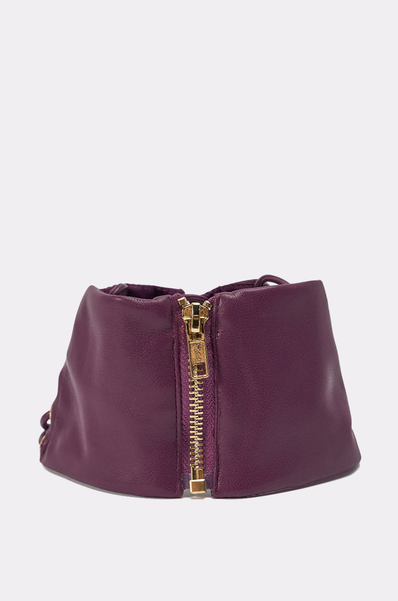 A close-up of a purple leather pouch with a gold zipper, styled next to the WHAT THE HELLY CHOKER, photographed on a plain white background. 3