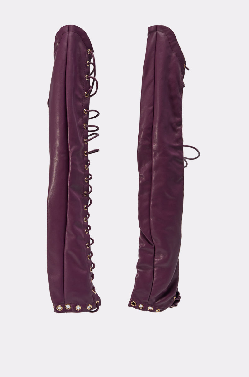 WHAT THE HELLY GLOVES, shown upright side by side on a white background, feature a tall purple leather design with lace-up detailing and metal eyelets up the sides—perfect to pair with matching lace-up boots. 6