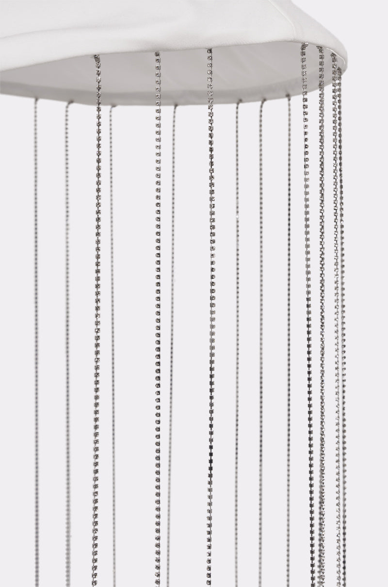 Close-up of the REALLY LIKE THAT BELT, a white dome-shaped accessory featuring multiple long, thin silver chains like rhinestone fringe, hanging vertically against a plain white background. 6